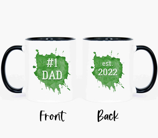 Two white coffee mugs with black handles. Customize your mug with the year he became a dad.