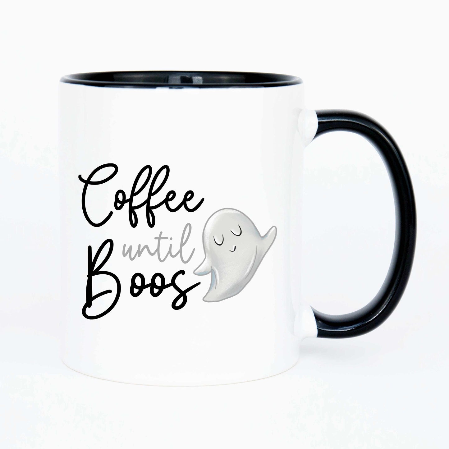 A cute coffee mug that reads coffee until boos in a script font with a cartoon ghost beside it.