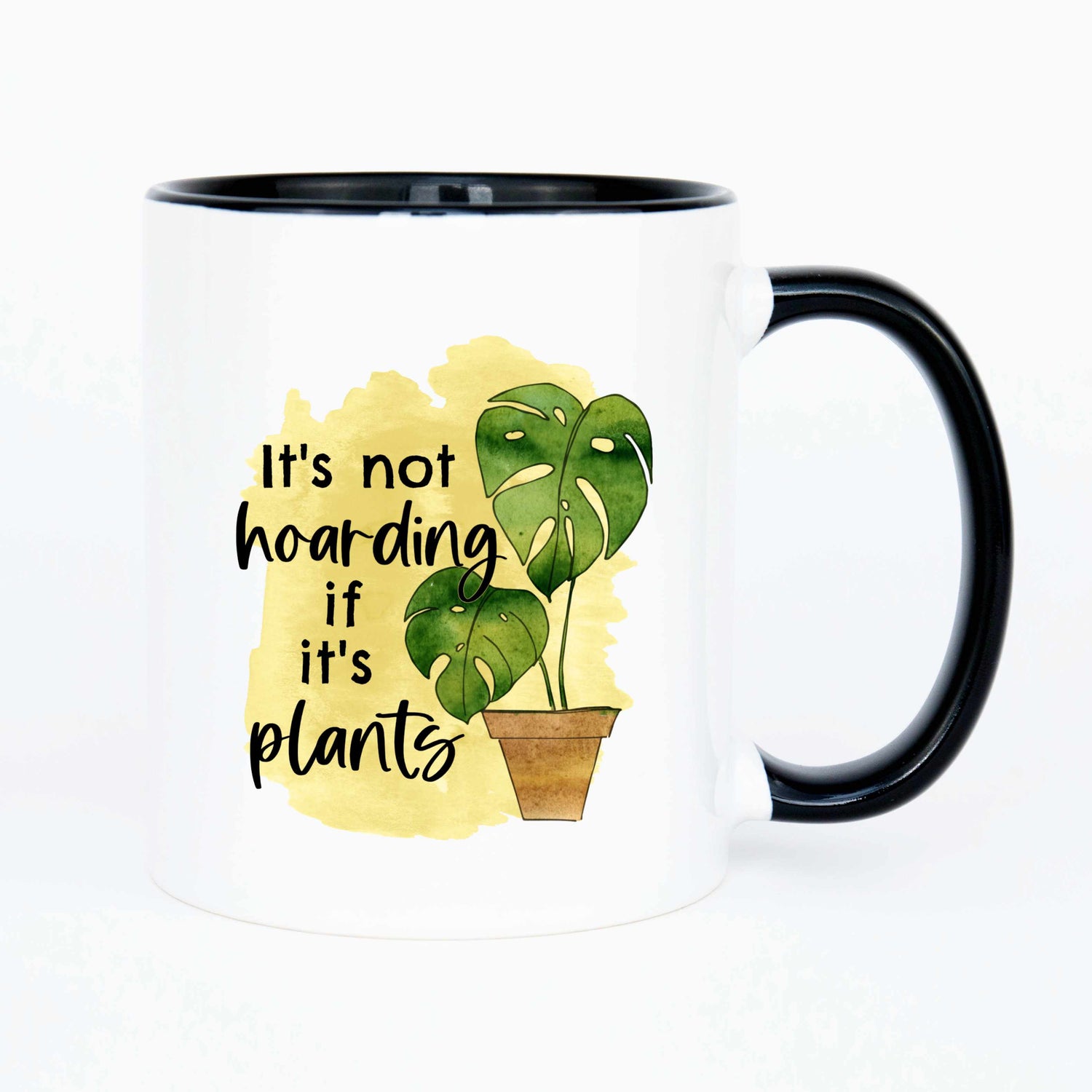 A white mug with a black handle with a picture of a potted monsterra that reads it's not hoarding if it's plants.