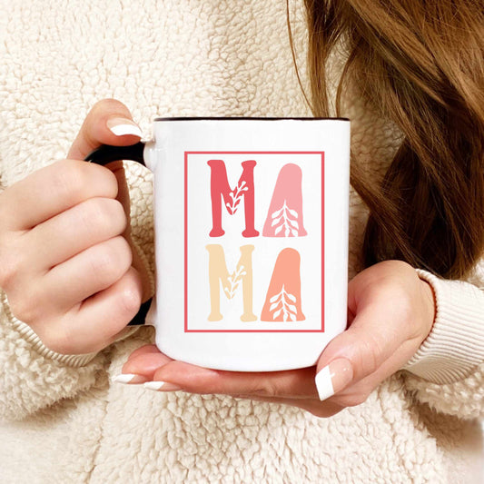 A close-up shot of a woman holding a mug that reads MAMA in shades of pink.