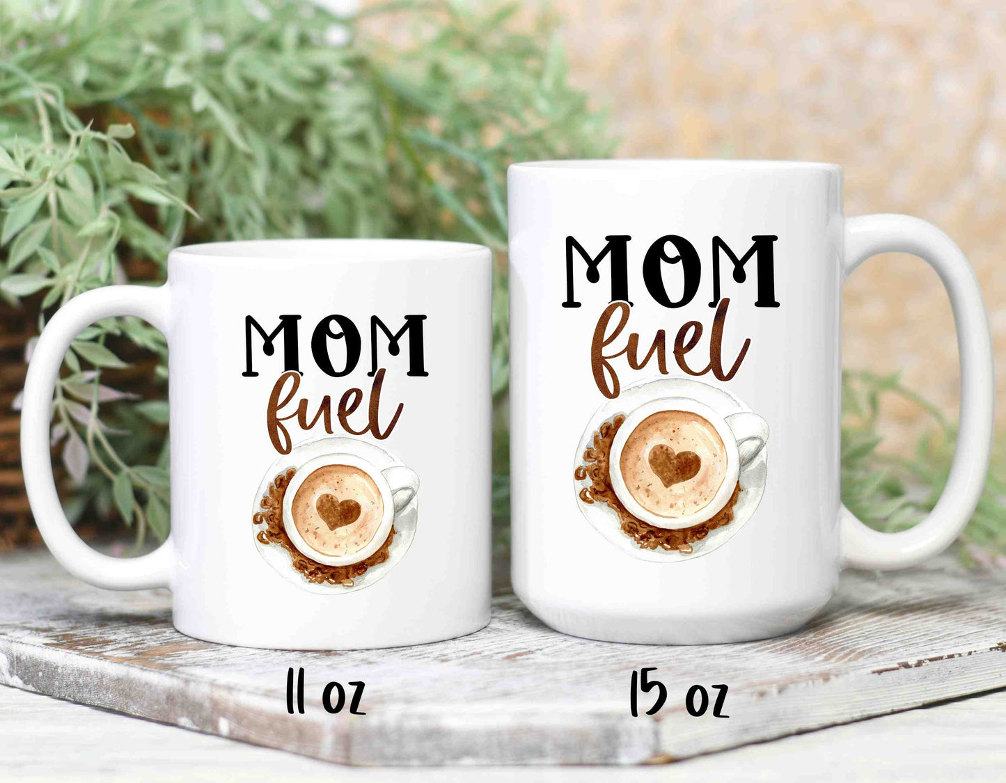 a small and large coffee mug that reads mom fuel in a script font.