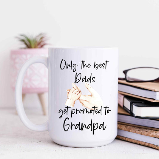 White mug with text that reads only the best Dads get promoted to Grandpa in a script font.