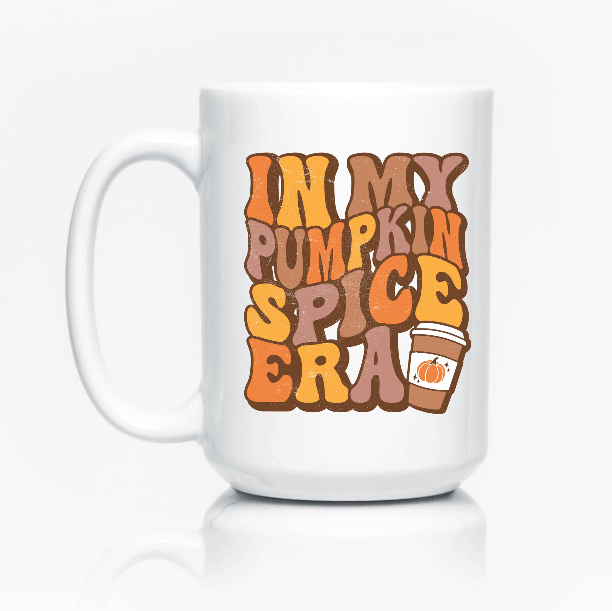 white coffee mug with 'in my pumpkin spice era' printed in brown, yellow, and orange bubble letters. 