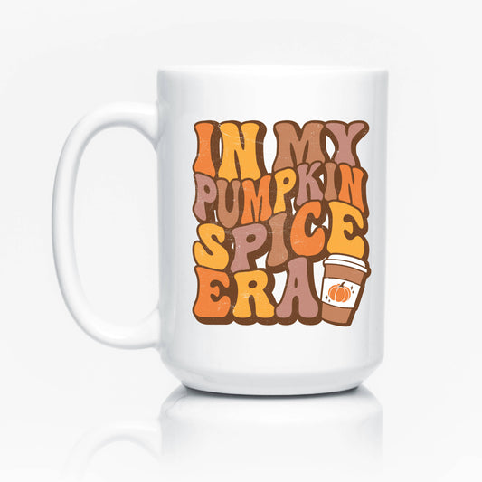 white coffee mug with 'in my pumpkin spice era' printed in brown, yellow, and orange bubble letters. 
