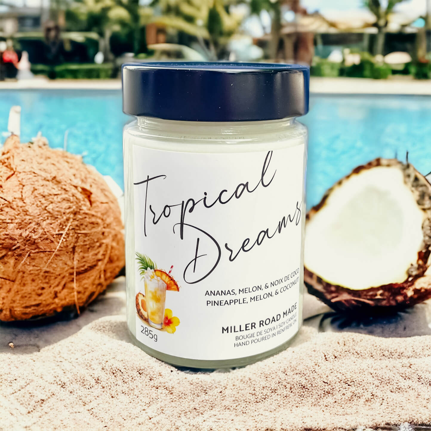 Caribbean fruity scented soy candle on a pool backdrop staged with coconuts.